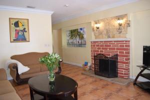 a living room with a couch and a fireplace at Home in the Heart of Miami in Miami