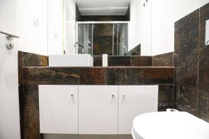 a bathroom with white cabinets and a large mirror at Central Lisbon Luxury Apartment in Lisbon +31 photos