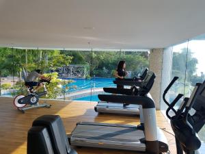 a gym with a view of a swimming pool at Beach Front Condominium at The Palm Wongamat in North Pattaya