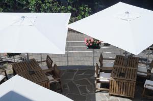 a group of chairs and umbrellas on a patio at Hotel Esperia in Genoa