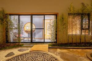 a room with a large glass door and a table at Su Xin Resort Inn in Zhangjiajie