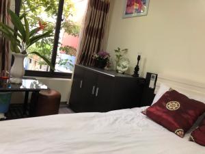 a bedroom with a bed with a red pillow on it at La ventana modern house in Hai Phong