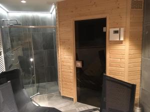 a bathroom with a shower and a glass door at Chalupa Pecivál Lipno in Lipno nad Vltavou +36 photos