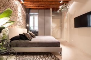En eller flere senge i et værelse på OFFICINE CAVOUR Piazza Cavour