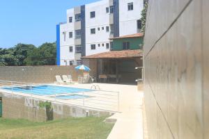 a swimming pool in front of a building at Pousada Recanto Setiba in Guarapari
