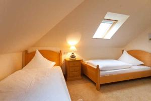a attic bedroom with two beds and a window at Ferienwohnung mit Balkon im Ostsee in Binz