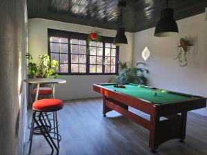 a billiard room with a pool table and a stool at Pyrenées Emotions, Eco-responsables, Nature, Sports Aventures in Malvézie