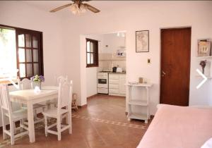 a kitchen and dining room with a white table and chairs at La casita uno y dos in Colón