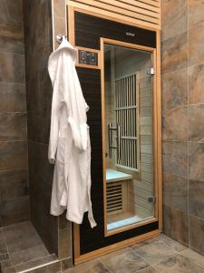 a bathroom with a towel hanging on the wall at Guest house Dobrynya in Velikiy Novgorod