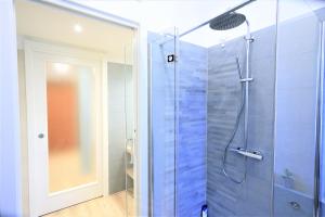 bagno con doccia e porta in vetro di 34 Via Giulio Carcano a Milano