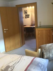 a room with a bed and a desk and a door at Haus Frainer in Wald am Arlberg