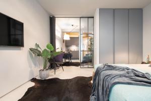 A bed or beds in a room at OFFICINE CAVOUR Piazza Cavour