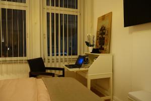 a bedroom with a bed and a desk with a laptop at Nettes, gemütliches Apartment in Wuppertal