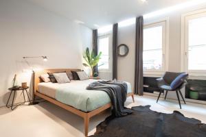 A bed or beds in a room at OFFICINE CAVOUR Piazza Cavour