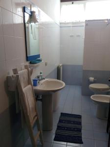 a bathroom with two toilets and a sink and a mirror at Suite Marina in Trapani