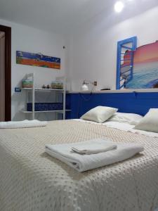 a bedroom with two beds with white towels on them at Suite Marina in Trapani