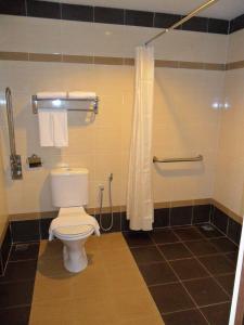 a bathroom with a toilet and a shower at Hotel Seri Malaysia Kangar in Kangar