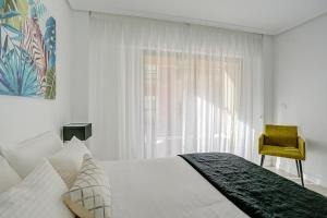 Llit o llits en una habitació de Un Lujo en el Corazón de Alicante