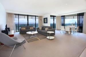 a living room with couches and a table and chairs at Luxury 3 Bedroom in heart of Broadbeach in Gold Coast