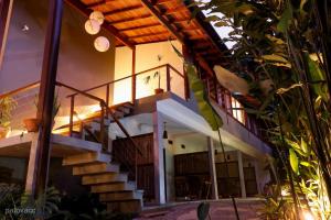 a house with a staircase in front of it at Moksha Surf Yoga in Ubatuba