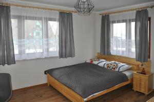 Posteľ alebo postele v izbe v ubytovaní Apartamenty JSZI