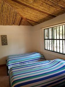 a bed in a room with a window at Hacienda Gonzabal in Loja