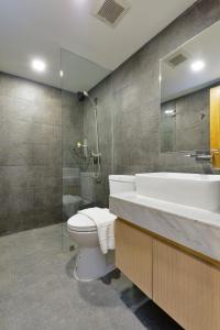 a bathroom with a toilet and a sink and a shower at iCheck inn Sukhumvit 19 in Bangkok