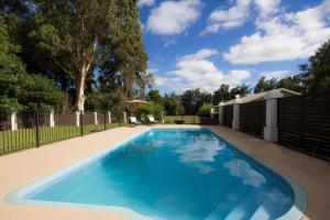 a large blue swimming pool in a yard at Mudgee Country Grandeur at this Elegant Group Getaway in Mudgee