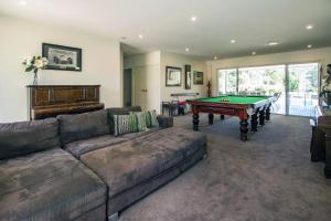 a living room with a couch and a pool table at Mudgee Country Grandeur at this Elegant Group Getaway in Mudgee
