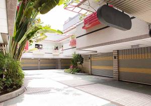 a hallway of a building with doors and plants at Royal Group Motel Wu Yin Branch in Kaohsiung