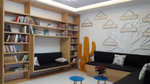 a living room with a couch and bookshelves at Siro House Da Nang Homestay in Da Nang