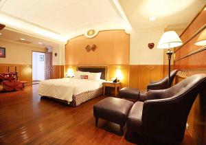 Habitación de hotel con cama y sofá en Royal Group Motel Tainan Branch, en Tainan