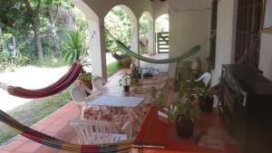 a patio with a table and chairs and hammocks at Lo de Fede in Punta del Este