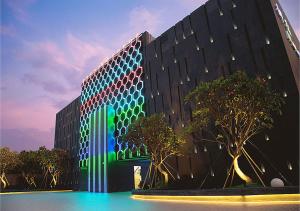 a building with green and blue lights on it at Royal Group Motel Feng Shan Branch in Kaohsiung