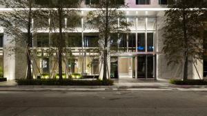a building with trees in front of it at HUAN Serviced Residence in Taichung