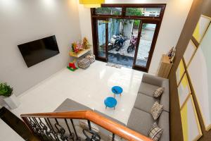 an overhead view of a living room with a couch and a television at Siro House Da Nang Homestay in Da Nang
