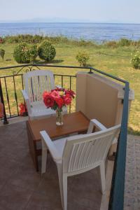 a table and two chairs on a balcony with the ocean at Sungate Beach in Rovies