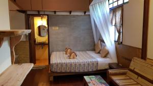 a small bedroom with a bed in a room at Longtail Beach Resort in Thong Nai Pan Yai