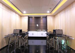 a conference room with chairs and a table with a window at Royal Group Hotel Ho Yi Branch in Kaohsiung