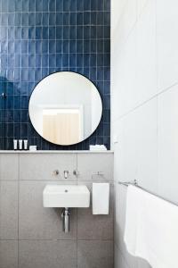 a bathroom with a sink and a mirror at Lorne Hotel in Lorne