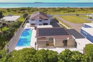 an aerial view of a house with a swimming pool at Waihi Beach Paradise Resort in Waihi Beach