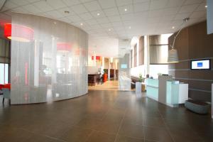 
a very large room with a lot of glass doors at Novotel Brugge Centrum in Bruges
