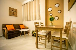 a living room with a table and a couch at Eshel Mansion - Boutique Suites in Beer Sheva