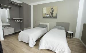 En eller flere senge i et værelse på Il posto accanto