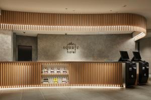 a lobby of a hotel with a sign on the wall at the square hotel KANAZAWA in Kanazawa +104 photos