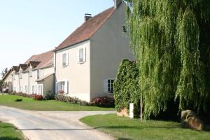 a row of houses on a residential street at La Ferme de Fontenelle in Amillis
