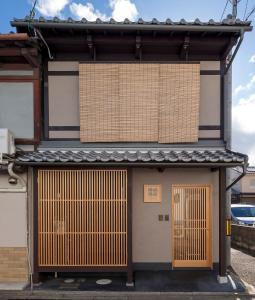 a building with two doors on the side of it at Shimabara Kaiden Machiya House in Kyoto