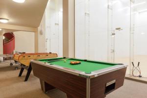 a room with a pool table and two tables at The Originals City, Hôtel Le Forum, Strasbourg Nord in Schiltigheim