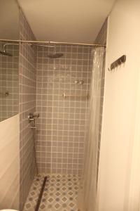 a bathroom with a shower with a shower curtain at Casa Glória in Lisbon