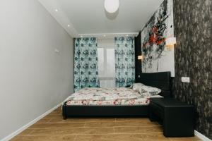 a small bedroom with a bed and a wall at Luxury Apartment in Sumy